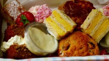 Selection of cakes and sweets for afternoon tea close up zoom flat lay selective focus