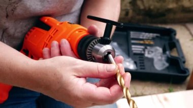 Fitting bit in electric power drill for diy medium shot 4k slow motion shot selective focus