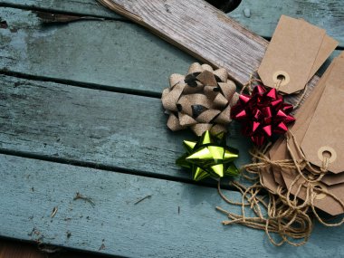 Christmas background with gift bag and tags on distressed wood background medium overhead selective focus