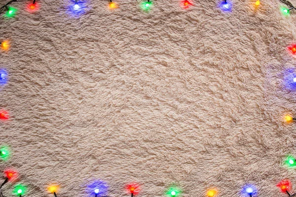 毛むくじゃらの背景にカラフルな輝くガーランドクリスマスのフレームモックアップ — ストック写真
