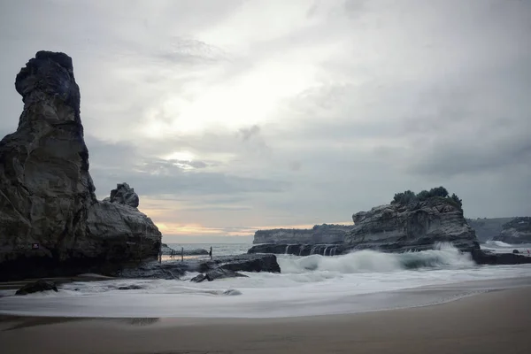 Klayar Beach, Pacitan, white sand beach. A stretch of white sand with clear waves breaks the beach, flanked by two coral hills on the right and left. on the right we can enjoy the beautiful view of Klayar Beach from the viewing post.