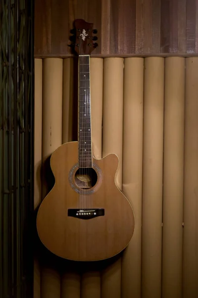 a type of acoustic guitar in which the sound produced comes from the vibration of the guitar strings being transmitted through the saddle and bridge where the strings are tied into the sound chamber.