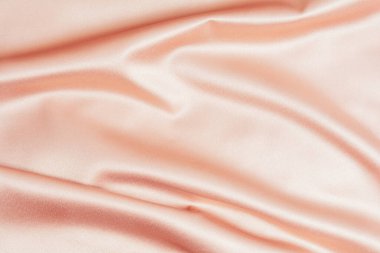 Pembe ipek ya da saten desenli arkaplan. Parlak tekstil dalgaları. Boşluğu kopyala