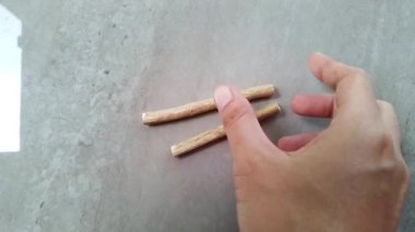 Hand take a siwak or miswak branch on the table