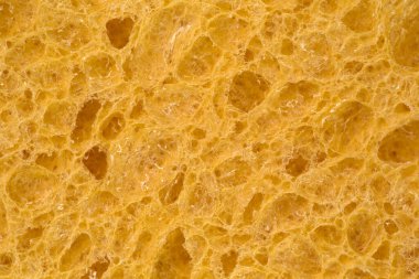 Bulaşık yıkamak için köpük süngerin yüzeyi. Gözenekli bir yapı. Temizlik ve hijyen. Yakın plan. Makro. Soyut, detaylı doku, yakın plan arkaplan.