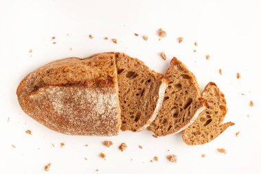 Wholegrain Organic Bread with crumbs isolated on white background. Sliced, cutted wheat bread. Top view. Food abstractions.