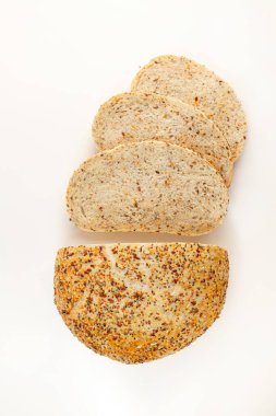 Wholegrain Organic Bread with crumbs isolated on white background. Sliced, cutted wheat bread. Top view. Food abstractions.