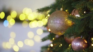 Noel ağacının dekore edilmiş dalları arka plandaki çelenk ampullerine karşı.