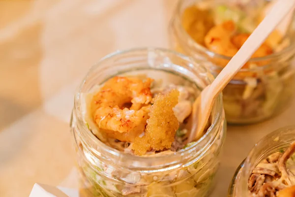 Convenient portioned serving of salads with shrimps in a small jar. Catering. — Stock Photo, Image