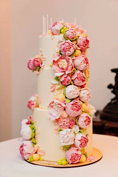 a large three-tier cake with sugar roses.