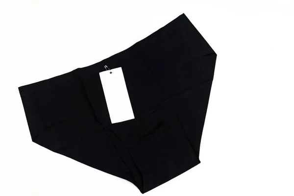 Calzoncillos sin costuras para mujer negros con una etiqueta sobre un fondo blanco. — Foto de Stock