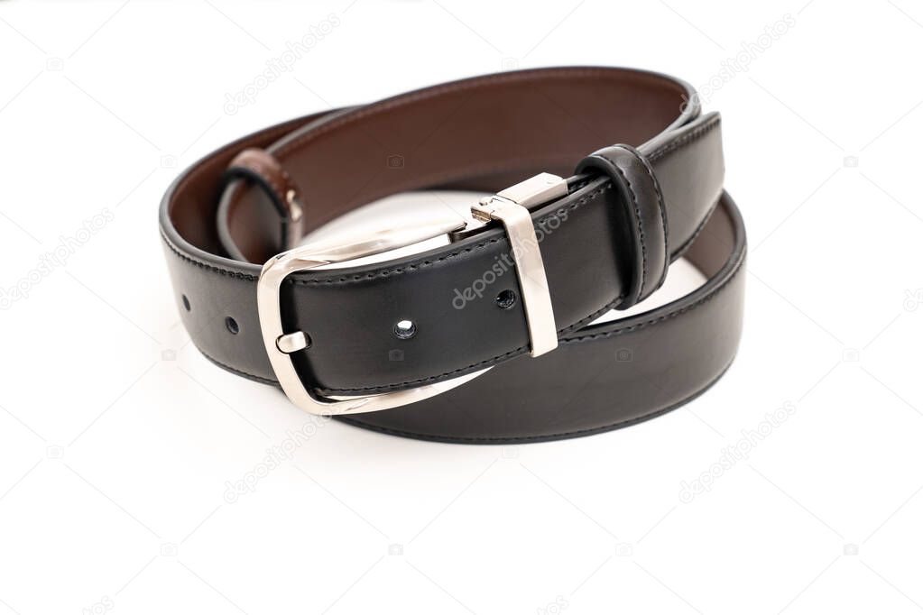 Double-sided black and brown leather belt with an unbuttoned buckle on a white.