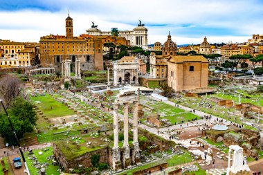 4 Aralık 2022 - Roma, İtalya: Satürn Tapınağı ile Roma Forumu üzerinde panoramik manzara, kemerler ve sütunlar.