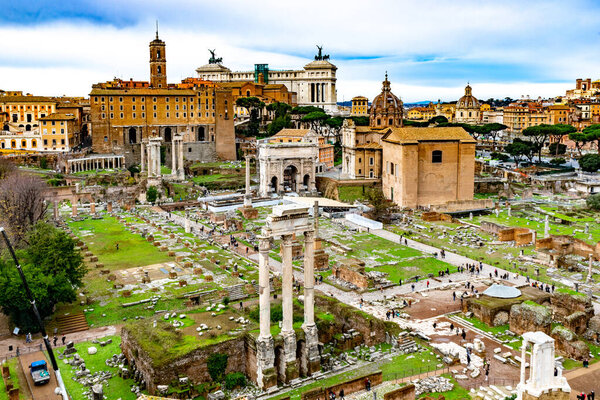 December 4, 2022 - Rome, Italy: Panoramic view over Forum Romanum with Temple of Saturn, arches and columns remains.