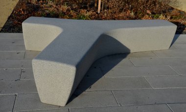 Meydanda yapay taştan yapılmış gri, beyaz bir bank duruyor. T ya da Y şeklinde beton döküm. Kışın ebedi çiçek yatakları sabah güneşinde donla kaplıdır..