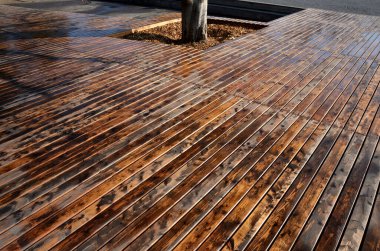 Impregnation of the terrace with oil paint. The color changes before painting and after application. the planks have a shiny and glaze and the structure of the wood is emphasized. weather protection