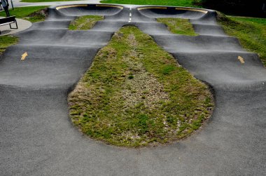 Otoparkta bisiklet yolu Pompalama (yukarı ve aşağı hareket) modüler pompa pisti boyunca bisiklet, scooter, kaykay ve dahili patenleri hareket ettirmek için pedal ve zıplama yerine kullanılır