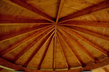 Marangozluğun ahşap kirişlerinden yapılmış pergola tavanı ahşabı sekizgen şeklinde naklediyor. Tepede deniz feneri gibi pencereler var..