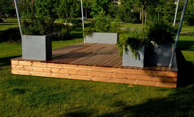 It is a heartwood that has a yellowish-brown to greenish appearance when fresh. separate wooden terrace on the lawn with fiberglass, plastic flower pots