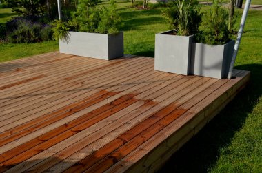 It is a heartwood that has a yellowish-brown to greenish appearance when fresh. separate wooden terrace on the lawn with fiberglass, plastic flower pots