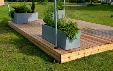 It is a heartwood that has a yellowish-brown to greenish appearance when fresh. separate wooden terrace on the lawn with fiberglass, plastic flower pots