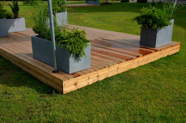 It is a heartwood that has a yellowish-brown to greenish appearance when fresh. separate wooden terrace on the lawn with fiberglass, plastic flower pots