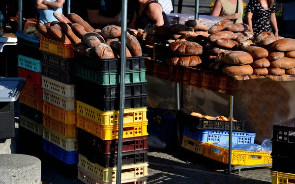 high prices and inflation force people to buy from the markets directly from the primary producers of fruits Vegetables and baked goods. round bread in plastic boxes.apricots and bakery under stands