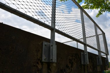 Terrace fencing, railings of metal pipes filled with steel cables cable mesh. fencing wire stainless steel fence. wooden floor, dance floor in the park, wire, galvanized railings, railing