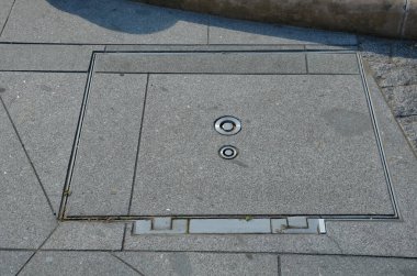 a hinged hatch with a patent lock to the underground of the city, where there are collector shafts with engineering networks. or the facility and subway entrance directly from the sidewalk