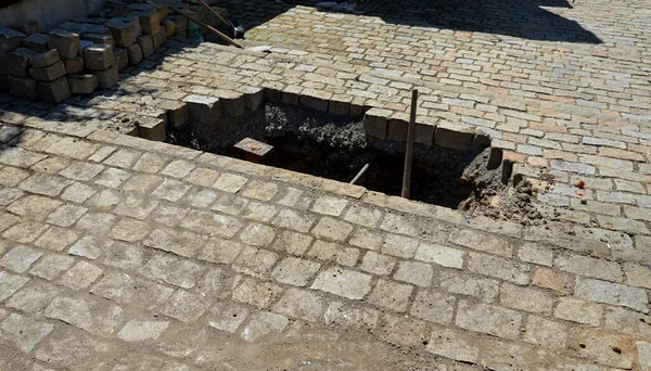 repair of the plastic supply pipe from the city water source in the cobblestone pavement. repair is difficult in a hot-water shaft, pit. the hole in the pipe is near the gas connection and cap.