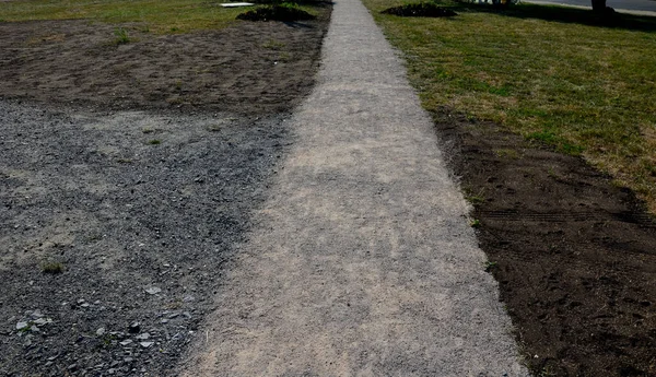 pedestrian path newly built compacted stone aggregate permeable surface soft for runners pedestrian cycle path forest path, park bench