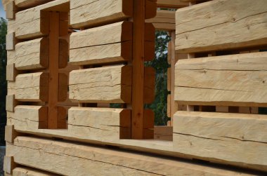 a carpenter built a log cabin with rough hewn beams. wood planing was not done before. authentic craftsmanship wooden log cabin. mortises for placing roof beams. gouging wood, ax, cut