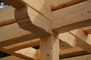 a carpenter built a log cabin with rough hewn beams. wood planing was not done before. authentic craftsmanship wooden log cabin. mortises for placing roof beams. gouging wood, ax, cut