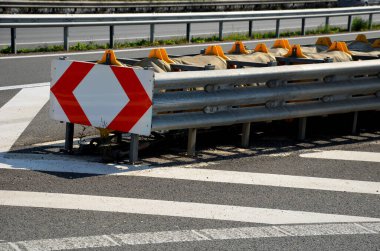 arresting system made of steel construction stops vehicles in a controlled manner in event frontal impact red and white end barriers can also redirect an uncontrollable car, shock absorber bent