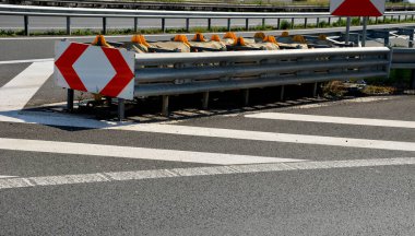 arresting system made of steel construction stops vehicles in a controlled manner in event frontal impact red and white end barriers can also redirect an uncontrollable car, shock absorber bent