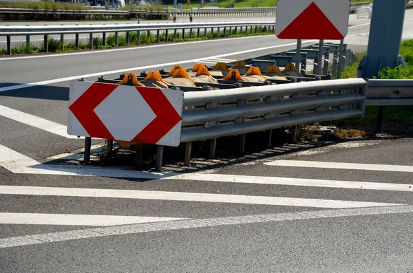 arresting system made of steel construction stops vehicles in a controlled manner in event frontal impact red and white end barriers can also redirect an uncontrollable car, shock absorber bent