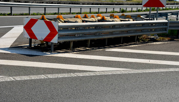 arresting system made of steel construction stops vehicles in a controlled manner in event frontal impact red and white end barriers can also redirect an uncontrollable car, shock absorber bent