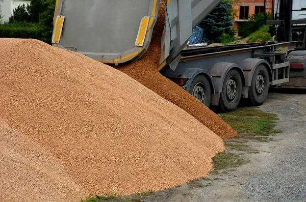 heavy load car. dump a load of gravel into a large pile. A metal hopper in the shape of a trough or tub can transport tens of tons of stone. three-axle semi-trailer. on a building site, unload