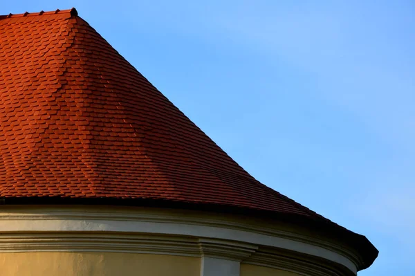 roofs lined with natural burnt. typical for cottages and stately residences, castles and noble villas. turrets roofed with red tiles similar to fish scales. the roofer must know how to work