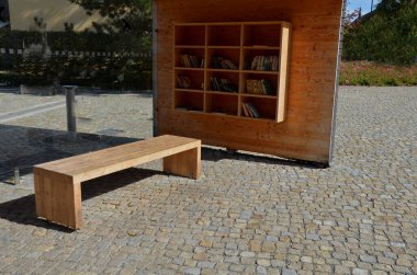 Otobüs durağının ahşap inşaatı, kitap ve dergi depolamak için rafları ve bankları olan bir çardak pergola barınağı. Duvarlar şeffaf cam ve ahşap kalaslarla kaplı. Çeşme