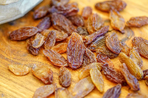 There are many naturally dried red raisins on the table