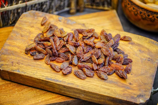 There are many naturally dried red raisins on the table