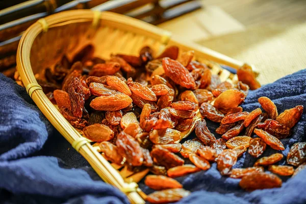 There are many naturally dried red raisins on the table