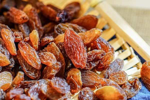 There are many naturally dried red raisins on the table