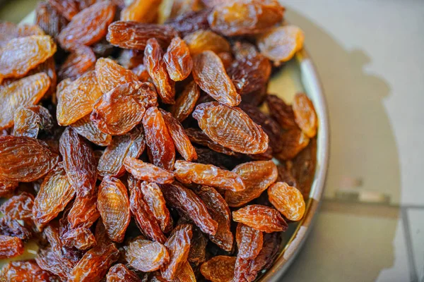 There are many naturally dried red raisins on the table