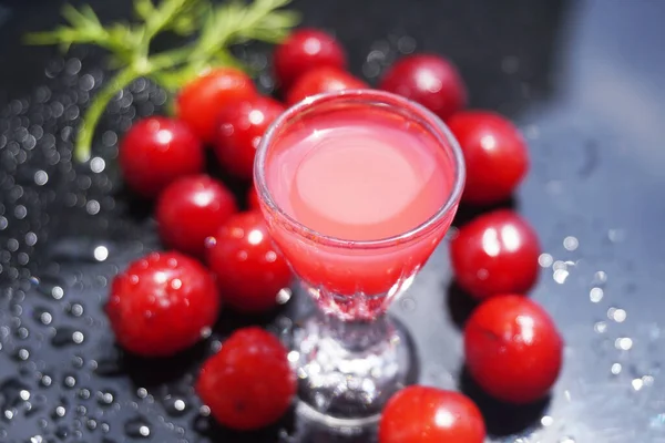 Cherry fruit on a black background with water drops - a beautiful background with organic food.