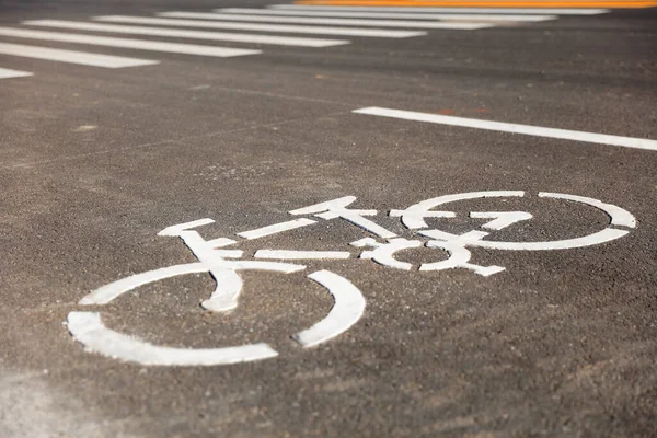 Bicycle lane signage on a street, Bicycle signage on asphalt pavement