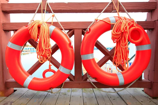 Life buoy on the dock, life buoy on the wooden railing