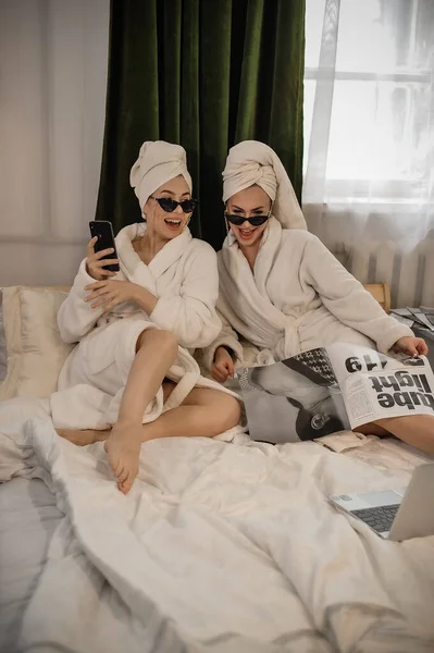 Beautiful Young Couple Bathrobes Pajama Lying Bed Looking Camera While — Zdjęcie stockowe