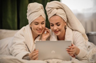 beautiful young women with tablet and towel in the kitchen